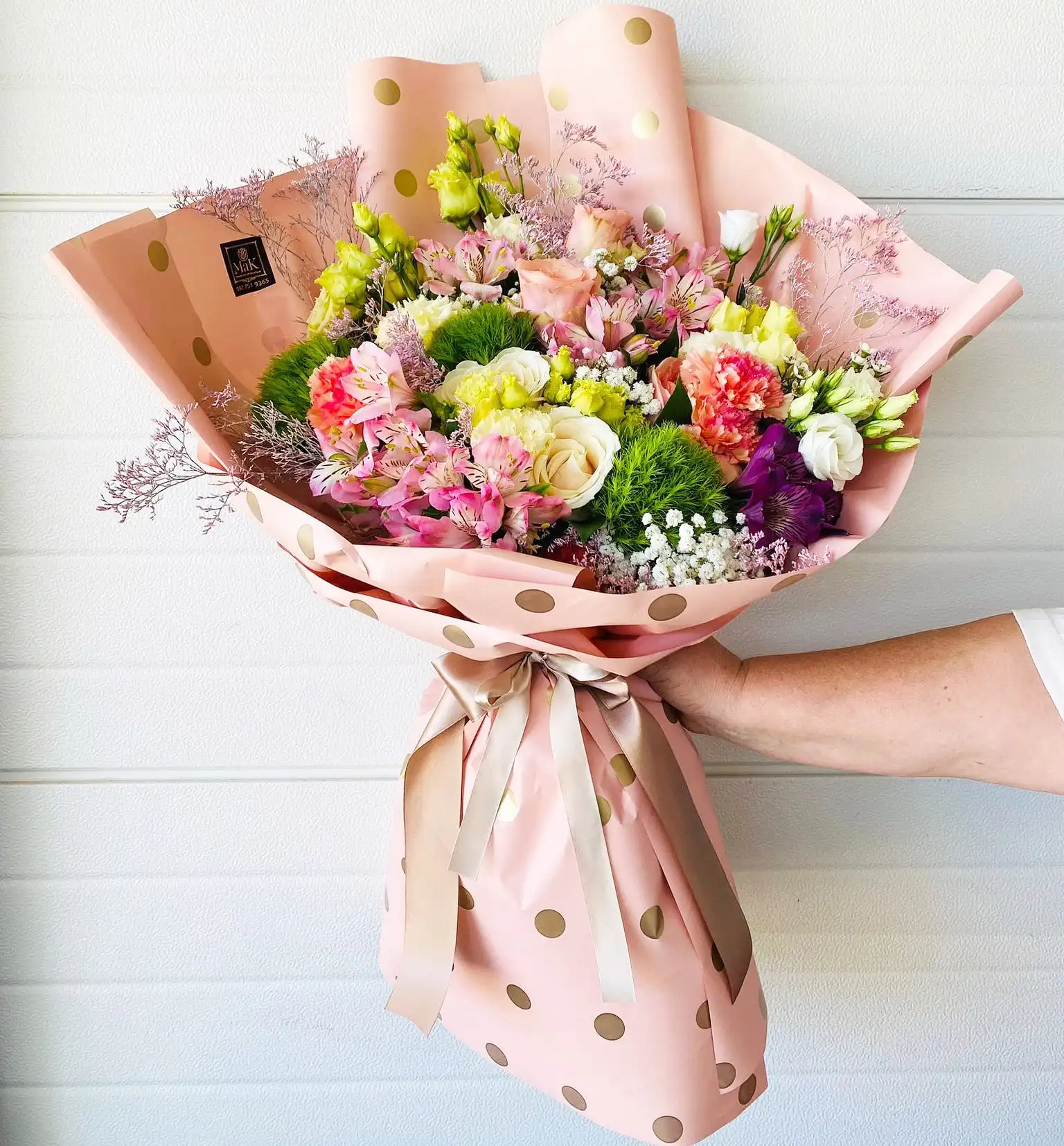 Hand-tied bouquet with carefully arranged flowers.