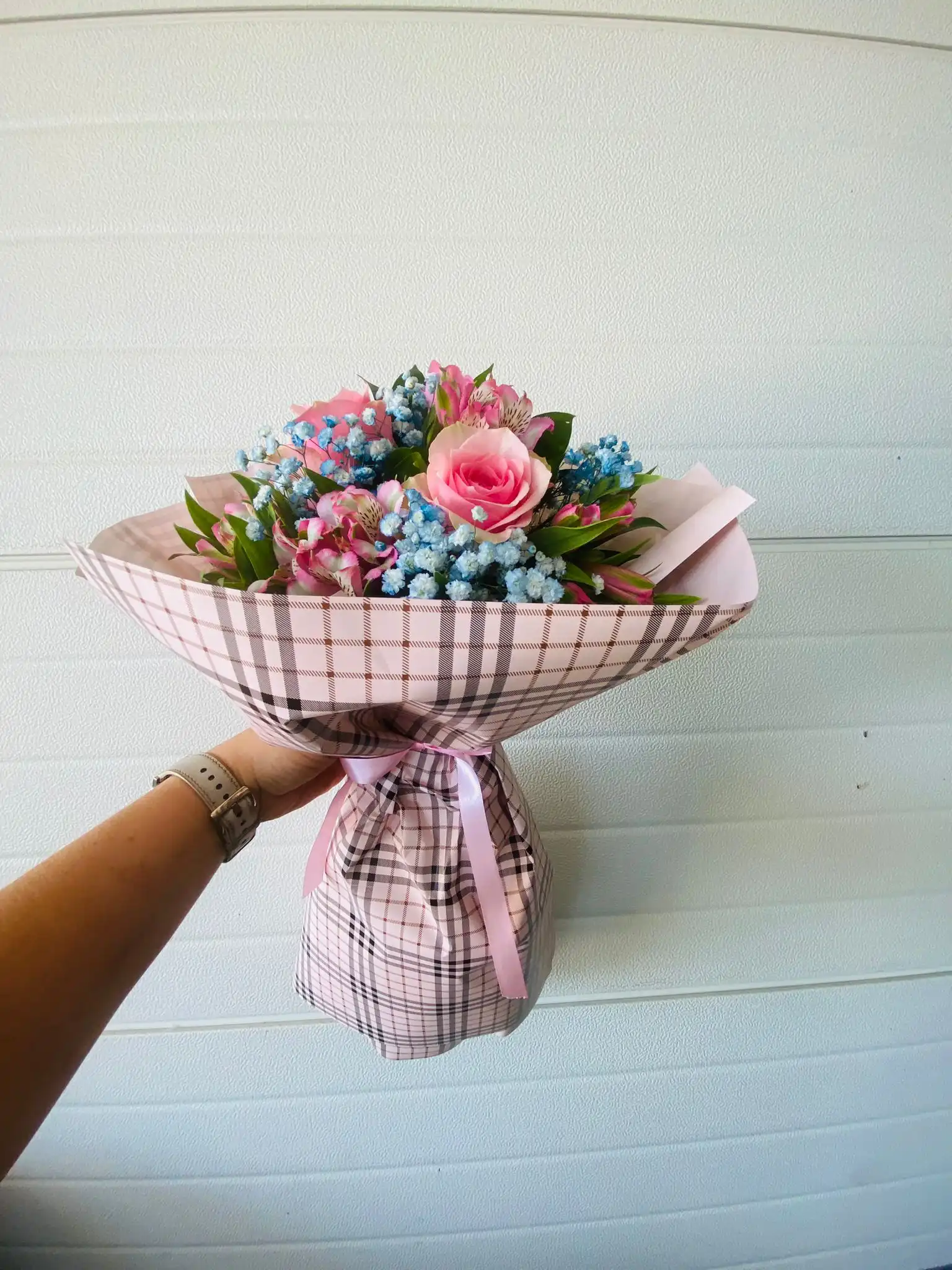 Hand-tied bouquet with carefully arranged flowers.
