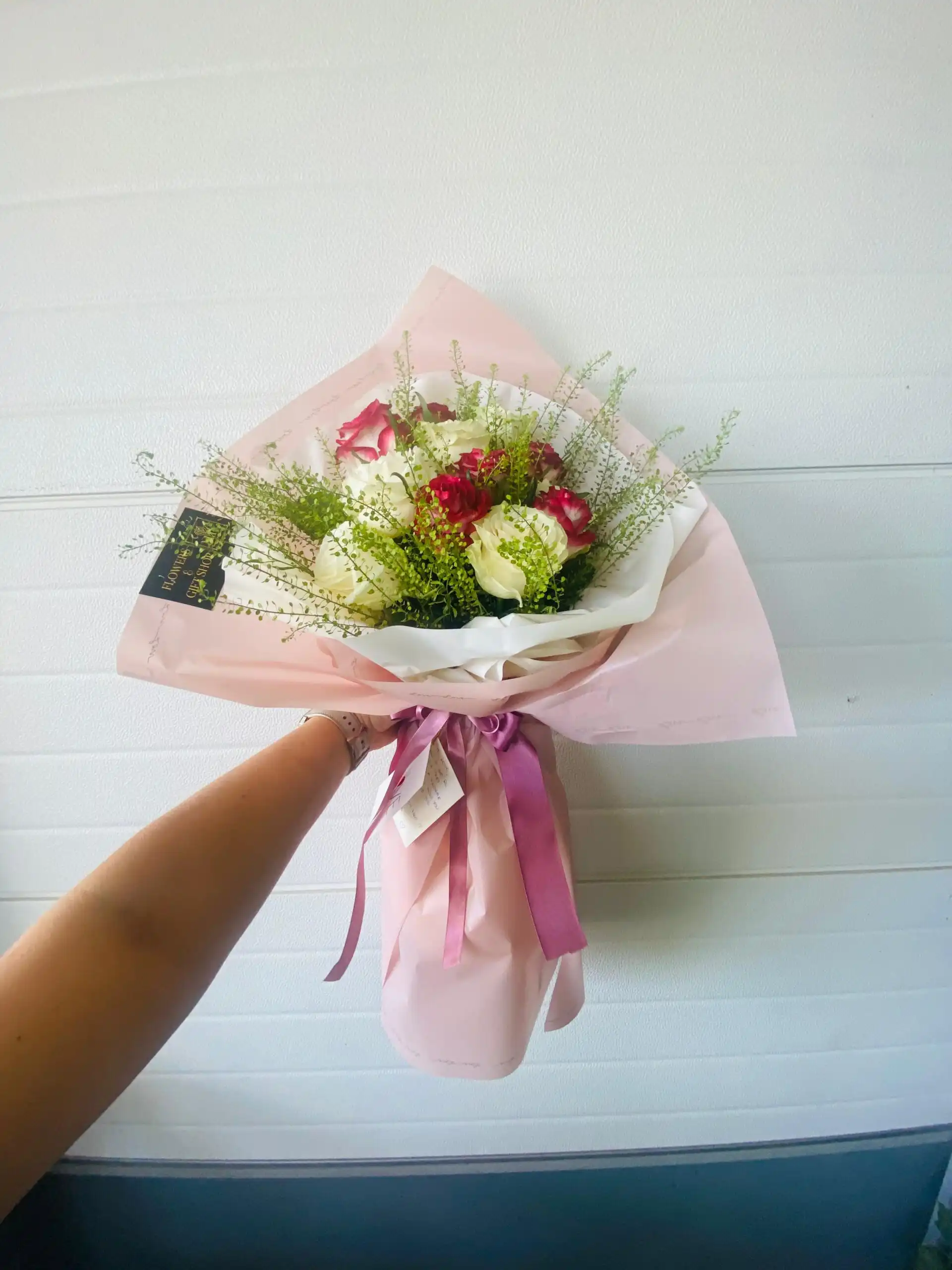 Hand-tied bouquet with carefully arranged flowers.