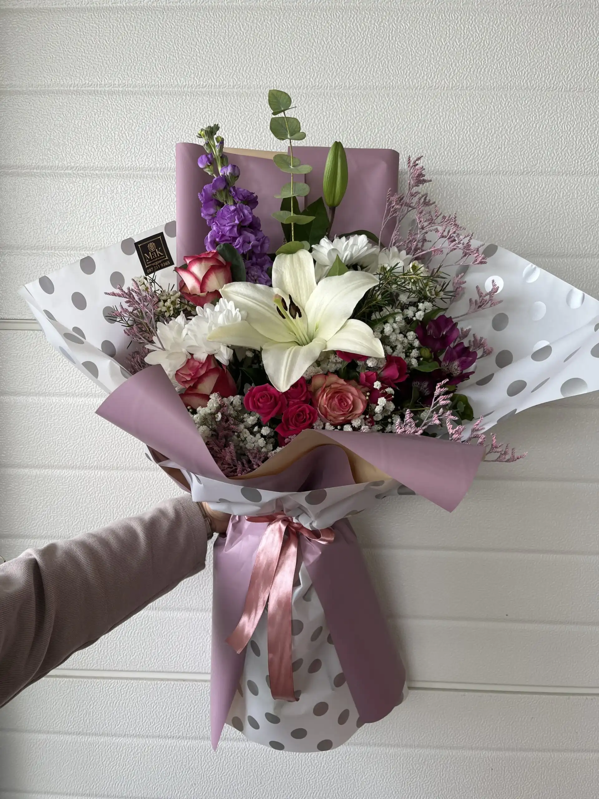 Hand-tied bouquet with carefully arranged flowers.