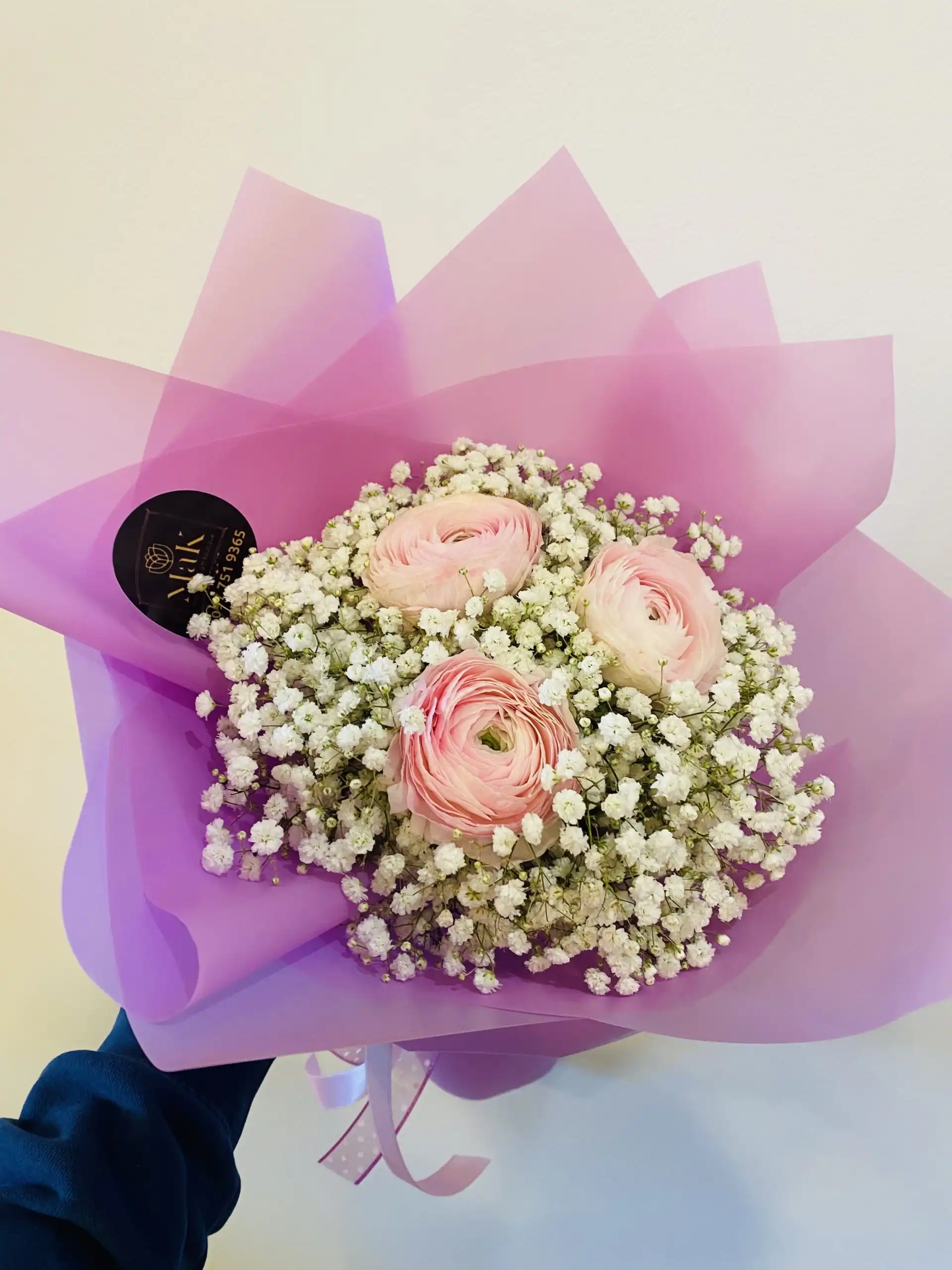 Hand-tied bouquet with carefully arranged flowers.