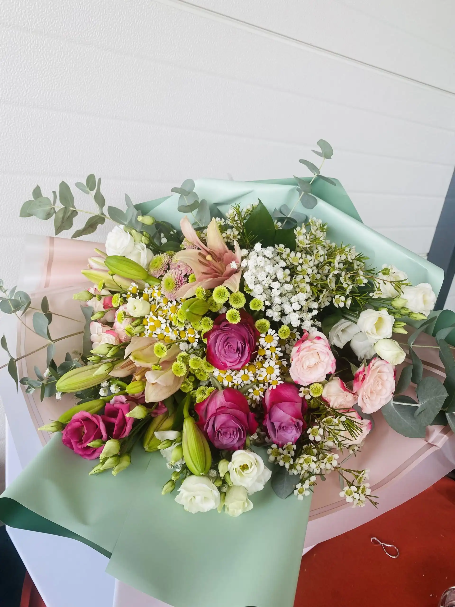 Hand-tied bouquet with carefully arranged flowers.
