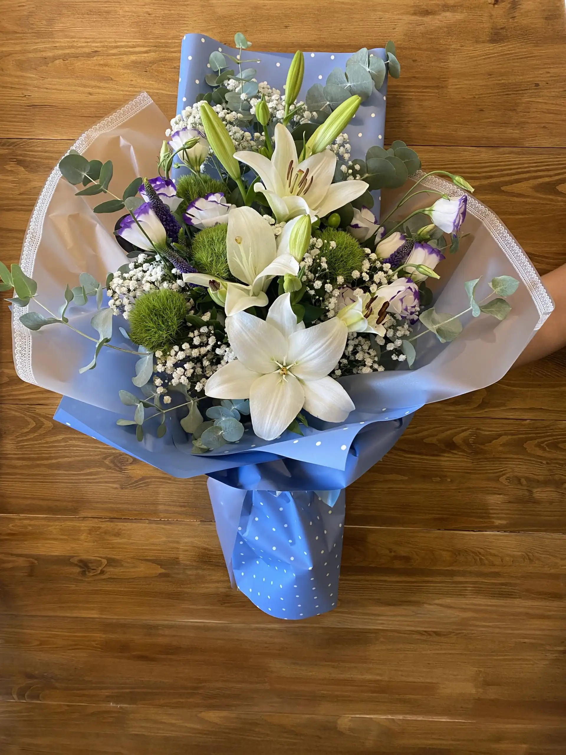 Hand-tied bouquet with carefully arranged flowers.