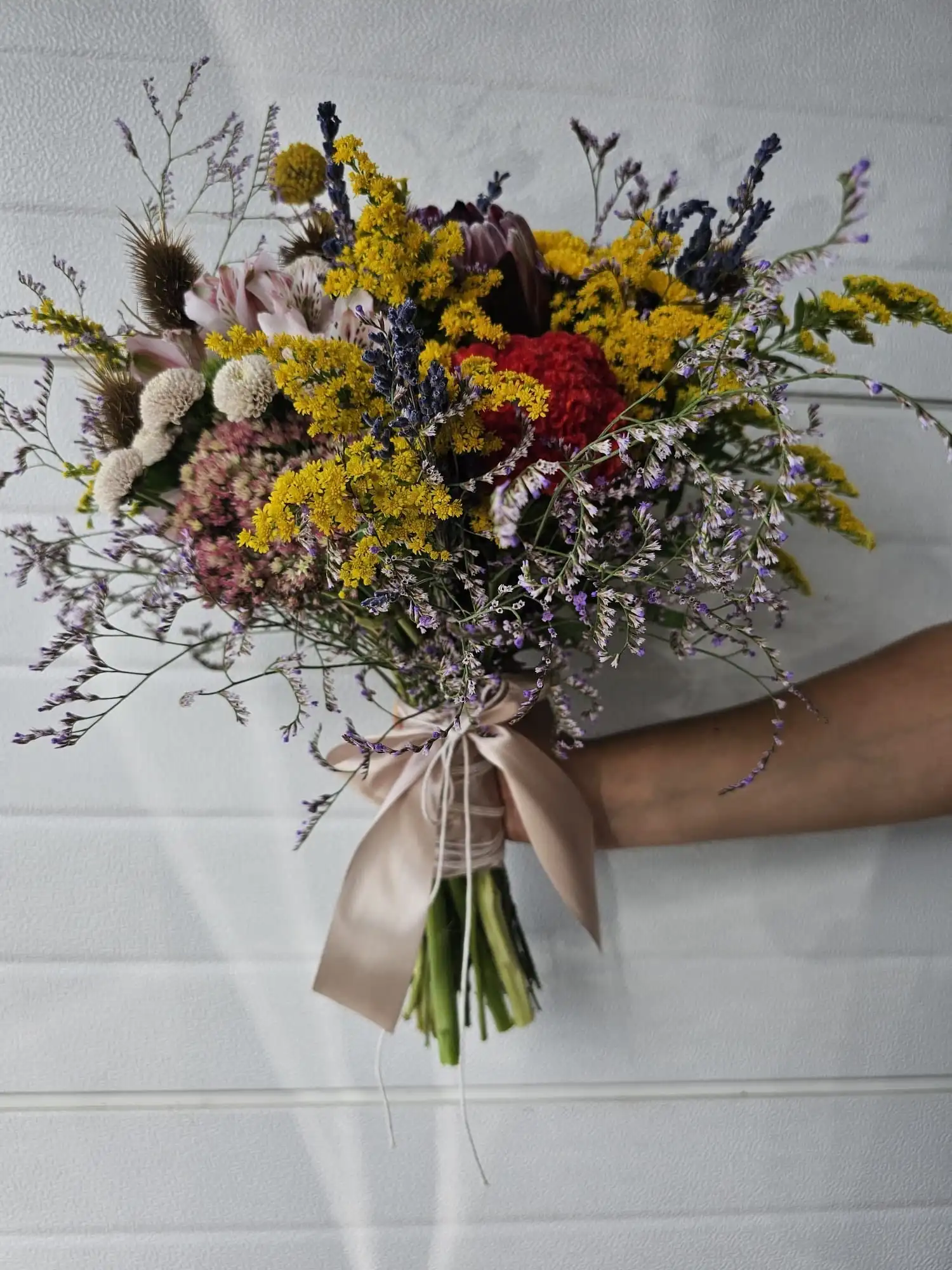 Hand-tied bouquet with carefully arranged flowers.