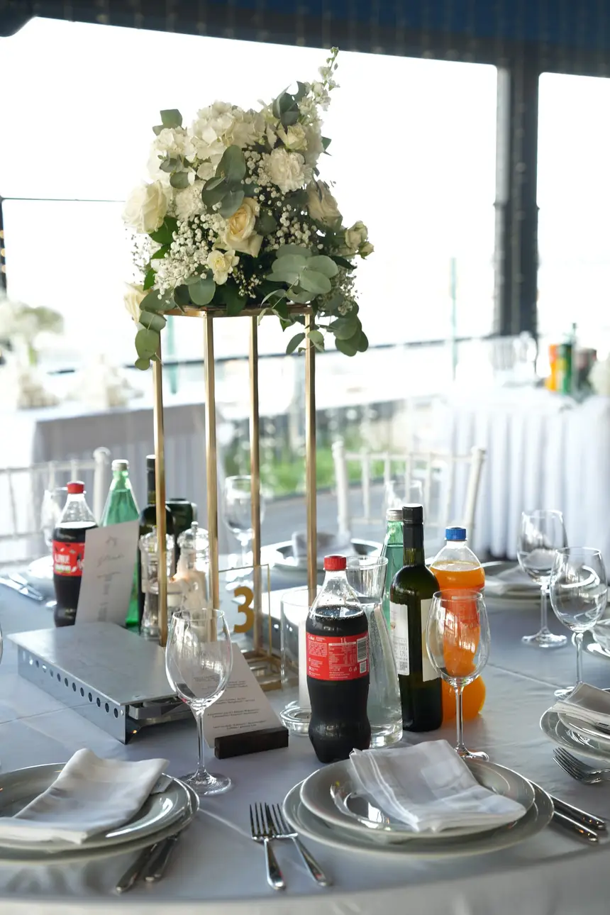 Floral decoration for a formal table with candles.